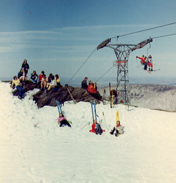 Gens prenant le soleil lors d'une journée de ski de printemps au mont Sutton en 1972